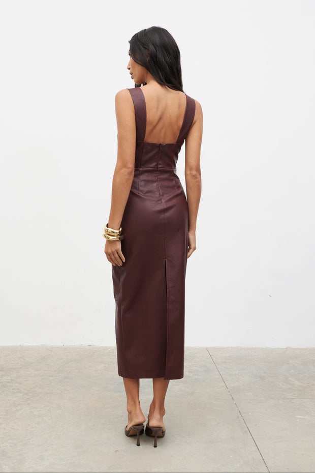 Woman wearing a brown dress with a white background